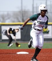 Free State runner A'Liyah Rogers heads toward third as the ball gets through to the outfield during the second inning against Shawnee Mission West on Thursday, April 25, 2013, at Free State High.