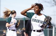 Free State shortstop A'Liyah Rogers signals three outs to the outfield after a strikeout by pitcher Meredith Morris during the third inning against Shawnee Mission West on Thursday, April 25, 2013, at Free State High School.