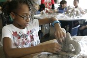 Asjah Harris sculpts an elephant-inspired clay teapot at the Boys and Girls Club of East Heights. Kansas University graduate student Eli Gold led the class in making the teapots and used Asjah's design as the inspiration for a teapot he fabricated in sterling silver.