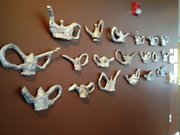 Each child who participated in Eli Gold's "From Their Hands to Mine" project will get a rough aluminum cast of the teapot design he or she created in clay. The casts and the single design that Gold re-created in sterling silver are on display through May 3 at the Lawrence Arts Center.