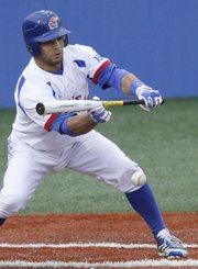Kansas University’s Ka’iana Eldredge lays down a bunt to drive in a run in the Jayhawks’ three-run fifth inning against Baylor, Friday, May 3, 2013, at Hoglund Ballpark. KU won, 3-2.