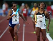 Kansas' Paris Daniels, left, edges out Texas' Courtney Okolo to win the women's 4X400-meter relay during the Big 12 Conference Outdoors on Sunday, May 5, 2013, in Waco, Texas.