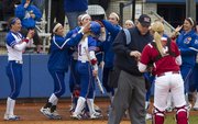 Kansas' Cassen Salamone (1) is congratulated by teammates after scoring during Kansas' senior day game against Oklahoma Sunday, May 5, 2013, at Arrocha Ballpark.