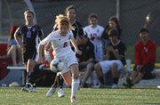Lawrence High's Ella Magerl looks to control the ball against Leavenworth during the first half, Thursday, May 9, 2013, at Lawrence High.