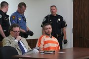 Kyle Flack's attorney, Ronald Evans, sits with Flack at his second court appearance May 13, 2013. Bobby Burch/The Ottawa Herald