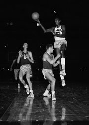 In this file photo from Dec. 5, 1955, Kansas University freshman Wilt Chamberlain (23) scores a goal during a freshman intrasquad game. At left is freshman Monte Johnson (6).