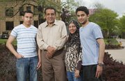 Salam Al Ghafli and his mother Fatimah will both graduate from KU on Sunday with bachelor's degrees. Salam and Fatimah took six classes together, and at Fatimah's insistence, sat side by side in the front row. Gathered Thursday in front of Strong Hall from left are Salam's brother Hassan Al Ghafli, his father Mansour Al Ghafli, his mother Fatimah Al Ghafli and Salam.