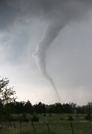 A tornado touches down southwest of Wichita, Kan. near the town of Viola on Sunday, May 19, 2013. The tornado was part of a line of storms that passed through the central plains. (AP Photo/The Wichita Eagle, Travis Heying)