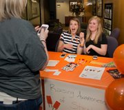 During a recent event at the Rehabilitation Institute of Kansas City to raise awareness about strokes in young people, Molly Ogden, center, shares a Kodak moment with Abby Anderson, 15, of Olathe. The girls met at the facility, where both have been rehabilitating from recent strokes.