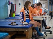 During one therapy treatment at the Rehabilitation Institute of Kansas City, Molly Ogden works on a puzzle while she wears a weighted sleeve to help stretch her right arm that was damaged from the stroke.