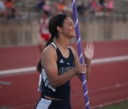 Mill Valley senior Emily Brigham reacts after setting a new 5A state track and field championship meet record with a 12-8 in the pole vault Friday in Wichita.