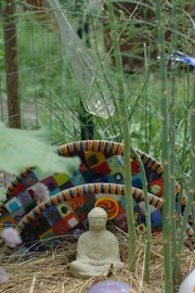 Bob Gent's backyard herb garden is dotted with sculptures, artwork — he's a glass artist — and, at one end, asparagus. The home of Gent and his wife, Kirsten Bosnak, at 18th and Barker streets is one of 18 stops on the 2013 Lawrence Food Garden Tour.