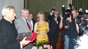 Wojciech Lesnikowski, a distinguished professor of architecture at Kansas University, displays his Laurel award from the city of Krakow, Poland, for a crowd of press photographers at an event there May 7. To his left is Krakow's mayor, Jacek Majchrowski.