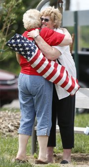 Cousins LaVon Harris, of Pomona, is hugged by Sarah Ann Bowman, back, of Boones Mill, Va., as the two reunite during the Hoover Family Reunion on Saturday