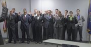 Police recruits are sworn in Tuesday by the Lawrence Police Department at the Investigations and Training Center. Back row, from left: John Pien, Ryan Douglas, Jonathan Gardner, David Nigro, Nicholas Simon, Narissa Dunn, Meagan Shipley. Front row, from left: Shawn Daubert, Skyler Richardson, Lindsay Bishop, Cody Williamson, Kristen Kennedy, Myra Gillum.