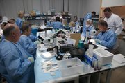 American scientists work in a NASA lab room at the Institute for Biomedical Problems in Moscow in late May, following the landing of the Bion-M1 satellite. They worked for about 24 hours straight to prepare mouse specimens for study. Joseph Tash, a professor at the Kansas University Medical Center, can be seen in the back of the room facing forward, with a magnifier atop his head.