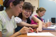 Sabi Rongish, center, and Grace Scrivo, both of Lawrence, work on reading a poem during an English language class Thursday evening at Plymouth Congregational Church, 925 Vermont St. For a donation of $40-$60, participates can partake in 18 sessions of either elementary or intermediate English or Spanish classes.