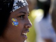 Kansas’ Paris Daniels — who contributed points in three events Saturday — sports a Jayhawk on her cheek.