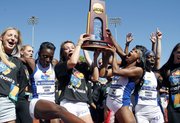 Kansas University's women's track team celebrates after winning the NCAA Outdoor track and field championships on Saturday in Eugene, Ore.