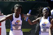 Kansas’ Diamond Dixon, left, takes the baton from teammate Denesha Morris in the 4X400 relay race at the NCAA Outdoor Track and Field Championship. KU placed sixth in the event Saturday in Eugene, Ore.