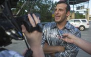 Wearing a shiny shirt provided by Cindy Self, Doug Gottlieb is interviewed by members of the media before heading into Abe and Jake's Landing for the annual Bill Self Basketball Boogie on Saturday, June 8, 2013.
