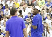 Kansas forward Jamari Traylor smiles with coach Bill Self as he talks with a gathering of young basketball campers during Self's basketball camp, Monday, June 10, 2013 at the Horejsi Center.