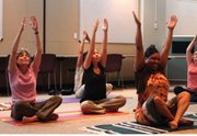 Employees at the Lawrence-Douglas County Health Department participate in a yoga session during a recent lunch break.