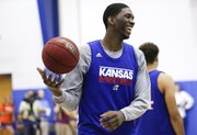 Kansas center Joel Embiid laughs during warmups before a scrimmage on Wednesday, June 12, 2013 at the Horejsi Center.