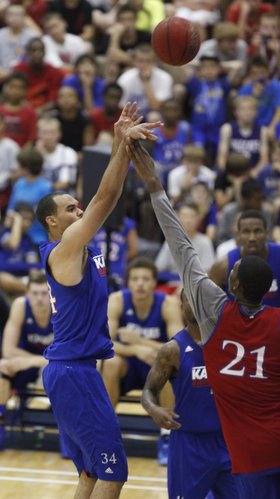 Blue team forward Perry Ellis puts up a jumper against Red team center Joel Embiid during a scrimmage on Wednesday, June 12, 2013 at the Horejsi Center.