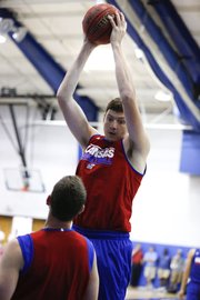 Red Team center Hunter Mickelson pulls down a rebound during a scrimmage before the basketball campers on Wednesday, June, 19, 2013 at the Horejsi Center.