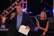 Kansas football coach Charlie Weis, left, and his wife, Maura, take the stage at a fundraiser for their Hannah & Friends charity on Friday, June 21, 2013, in Mayetta. The two-day event will culminate with a golf tournament today.