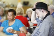 Dave Chipman, Lawrence, rubs his hat on his head as he sits through a 15-hour bridge game Friday, June 21, 2013, at the Kaw Valley Bridge Club. Local bridge enthusiasts played through the marathon-like game as a fundraiser for Alzheimer's research.