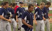 Members of the Lawrence Raiders walk back towards the dugout following their loss to Rawlings Wichita Reds James Sunday at Free State.