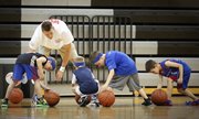 Sacramento Kings player and former Kansas center Cole Aldrich watches as young basketball players have a bit of trouble completing a ball-handling drill on Monday, June 24, 2013, during Aldrich's basketball camp at Olathe Northwest High School.