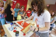 Lawrence artist Leslie Kuluva prepares her screenprinting materials during a workshop for teens, Friday, June 21, 2013, at the Lawrence Public Library.