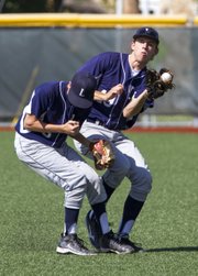 The Raiders' Jacob Seratte, right, avoids a collision with teammate Ryan Stagg while pulling down a fly ball during the Raiders' game against the Missouri Bucks Saturday at Lawrence High.