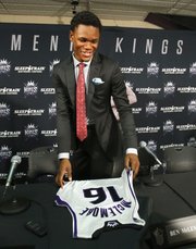 Sacramento first-round draft pick Ben McLemore picks up his jersey after a news conference Monday, July 1, 2013, in Sacramento, Calif.