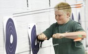 Sean Urban, 10, Oskaloosa, has to use a bit of force to remove one of his arrows that narrowly missed the center of his target.