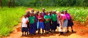 Peace Corps volunteer and 2007 Lawrence High School graduate Samantha Claypool-Temple poses with her students in Tanzania.