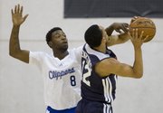 The Clippers’ Elijah Johnson, left, tries to block a shot by Atlanta’s John Jenkins in an NBA Summer League game Friday, July 12, 2013, in Las Vegas.