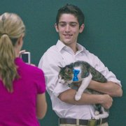 Mason Kelso, 17, along with his cat, Indiana Jones, were at the Douglas County Fair Grounds as 4-H club members showed off their pets to judges on Saturday July 20, 2013.