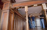 From left Rob Garcia, Shawnee, KU junior Zach Williams, Olathe, and Bill Joeckel, Osawatamie, gather on a second floor landing at the KU Sigma Nu house Saturday evening during a tour of the fraternity house led by Williams. Williams was recounting stories of mysterious events in the house prior to a team of Elite Paranormal and K.C. Paranormal Studies members doing a ghost investigation Saturday night.