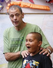Using 9-year-old Kolton Scott as a prop, special guest Stephen Ritz tells kids from the Boys & Girls Club of Lawrence on Thursday that the amount of weight he has lost in recent months, 110 pounds, is nearly equivalent to the full weight of Kolton.