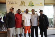 Mario Chalmers, center, poses with Kansas assistant coaches Jerrance Howard, second from left, Kurtis Townsend, second from right, and Norm Roberts, right, prior to Chalmers' charity golf tournament on Monday, July 29, 2013, at Alvamar.