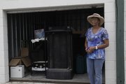 Leslie Carper, of Lawrence, checks on a storage unit at A1 Self Storage, 1717 W. 31st Street, which was ransacked by thieves in May. Three people arrested Wednesday are facing charges in a case that police say links this burglary with more than a dozen others this year.