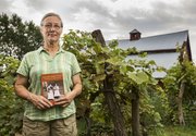Joy Lominska holds her newly published book, "The Old Home Place, The Story of a Kansas Farm," outside her family farm in rural southern Jefferson County, Saturday, Aug. 3, 2013. The book details the farm&squot;s history dating back more than 100 years.
