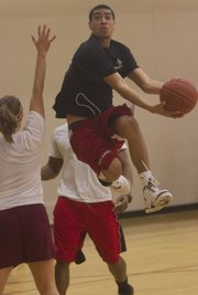 The Jayhawk Health Initiative hosed a 3-on-3 basketball tourney called "Hoops for Health" to raise funds for a medical mission trip. Pictured, high-flying Sean Wickliffe, 23, of Lawrence, skies for two points, during the tournament held at Ambler Student Recreation Fitness Center.