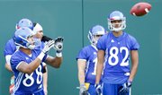 Kansas receiver Nick Harwell looks to grab a pass during drills on Friday, Aug. 9, 2013. Nick Krug/Journal-World Photo