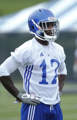 Kansas defensive back Dexter McDonald waits in line to participate in a drill during practice on Friday, Aug. 9, 2013.