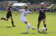 Kansas University’s Caroline Kastor (10) tries to get a shot past Nebraska-Omaha defender Jordyn Braun (15) during an exhibition soccer match, Sunday, Aug. 18, 2013, at the Jayhawk Soccer Complex.
